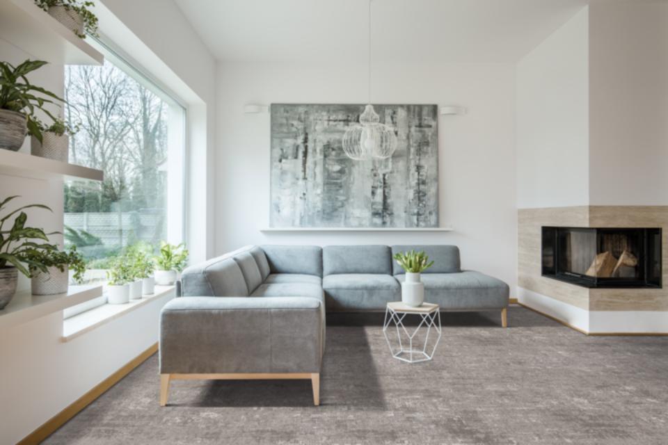 grey patterned carpet in living room with modern wood and light decor.